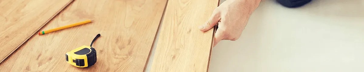 A professional installing wood flooring in Omaha, NE