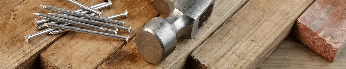 Hammer and nails on hardwood flooring boards in Omaha, NE