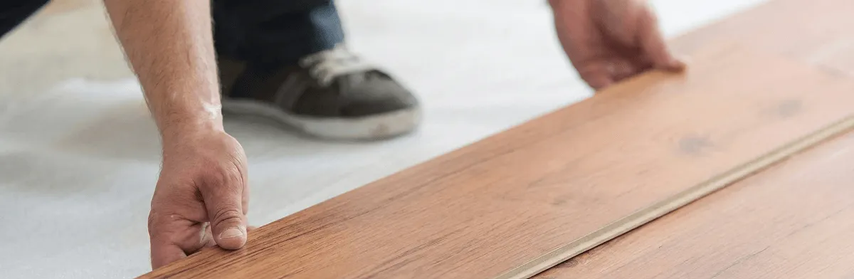 A professional installing laminate flooring in Omaha, NE
