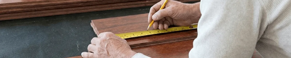 A professional installing wood flooring in Omaha, NE